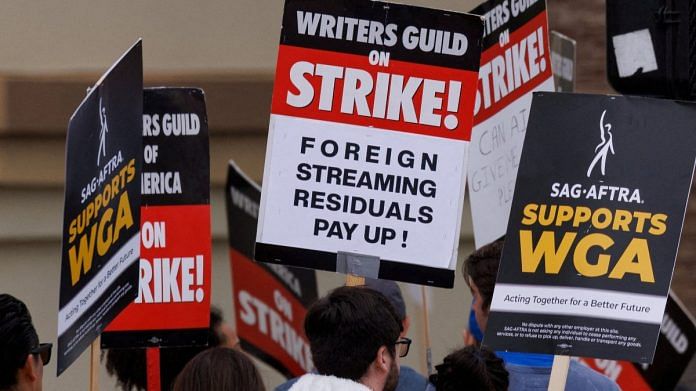 Members of SAG-AFTRA and the Writers Guild of America walk the picket line outside Paramount Studios in Los Angeles, California, US | Reuters