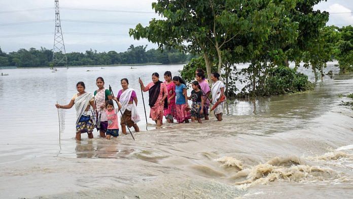 Villagers wade through the flood water at Dhamdama in Nalbari district of Assam | ANI