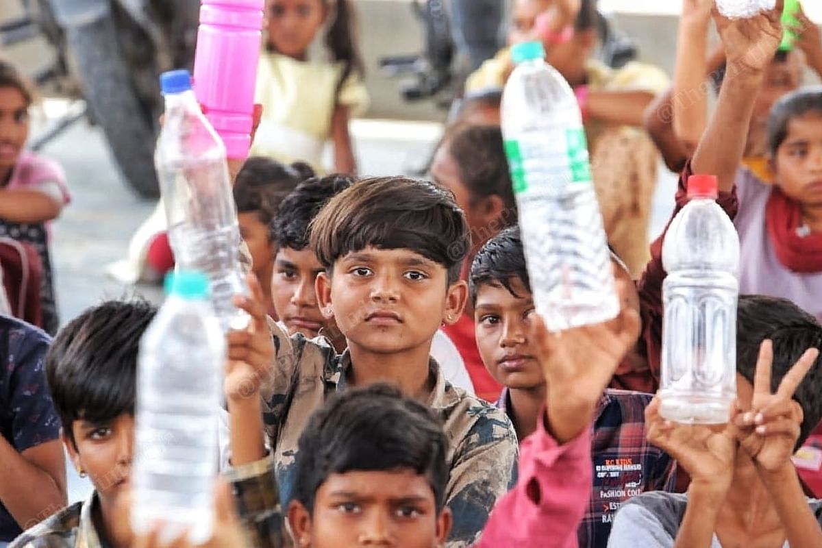 The primary school doesn't have a proper water system. Children here wave their water bottles. | Photo: Praveen Jain | ThePrint