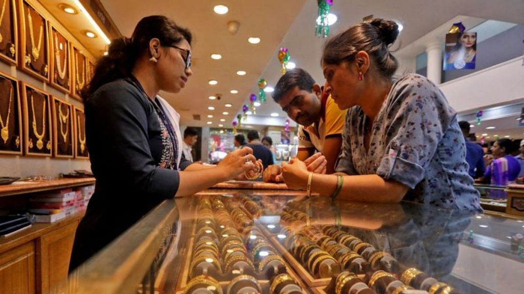 People shop for gold ornaments at a jewellery showroom in Mumbai | Reuters/Niharika Kulkarni