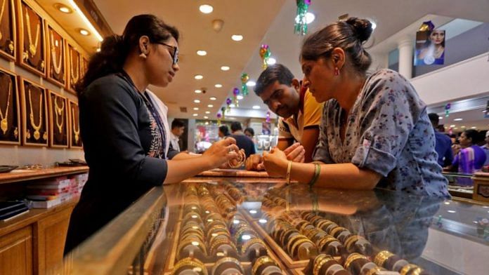 People shop for gold ornaments at a jewellery showroom in Mumbai | Reuters/Niharika Kulkarni