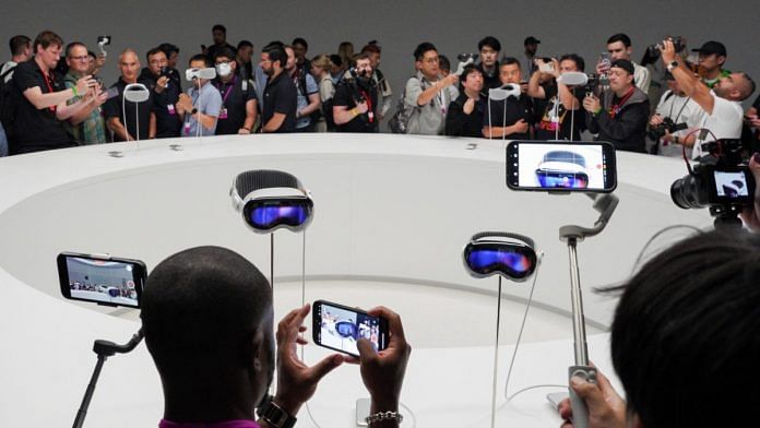 People use phones as Apple's Vision Pro headsets are on display at Apple's annual Worldwide Developers Conference at the company's headquarters in Cupertino, California, on 5 June 2023 | Reuters