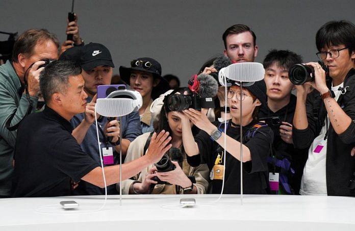 People use cameras as Apple's Vision Pro headsets are on display at Apple's annual Worldwide Developers Conference at the company's headquarters in Cupertino, California, on 5 June 2023 | Reuters