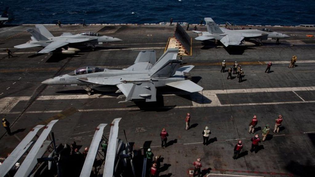 U.S. navy F-18 Super Hornet and crews are seen on the flight deck on the USS Nimitz, off the coast of Busan, South Korea, 27 March 2023/Reuters