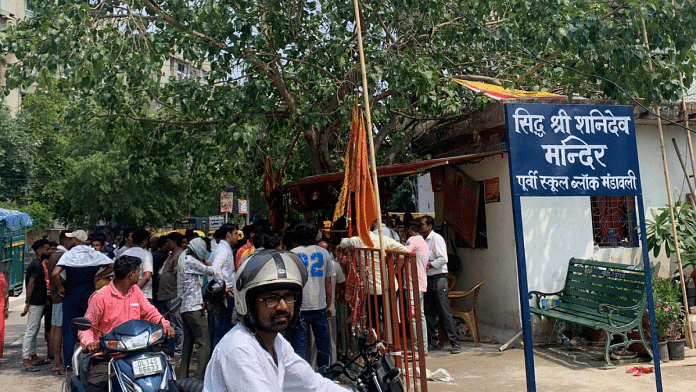 Residents gather in front of the Shani Dev Mandir in east Delhi | Shania Mathew | ThePrint