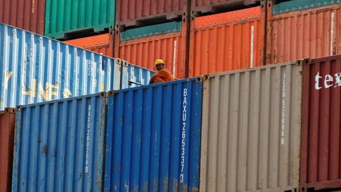 A worker sits on a ship carrying containers at Mundra Port in Gujarat | File Photo: Reuters