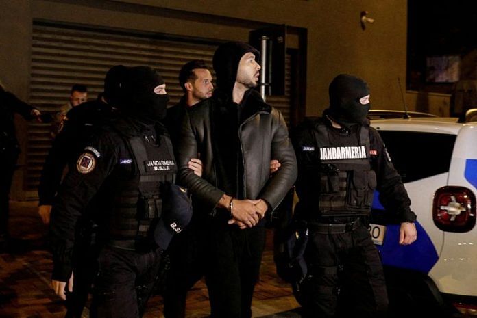 Andrew Tate and Tristan Tate are escorted by police officers in Bucharest, Romania | File image via Inquam Photos/Octav Ganea via Reuters