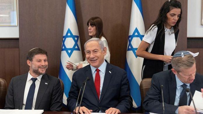 Israeli Prime Minister Benjamin Netanyahu, centre, and Finance Minister Bezalel Smotrich, left, attend a weekly cabinet meeting in the prime minister's office in Jerusalem, on 18 June, 2023 | Reuters