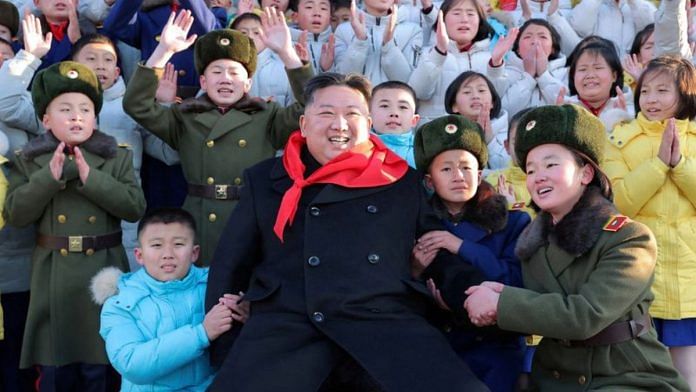 North Korean leader Kim Jong Un poses for a group photo with KCU representatives | KCNA via Reuters