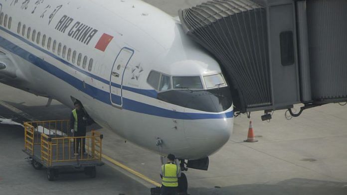 Workers work on a flight of Air China on the tarmac at the Beijing Capital International Airport in Beijing on 28 March, 2016/Reuters