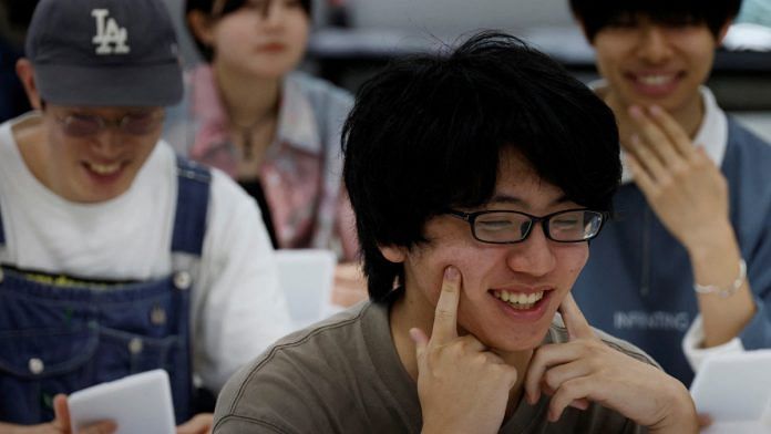 Students practice smiling at a smile training course at Sokei Art School in Tokyo | Reuters/Kim Kyung-Hoon