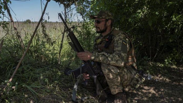 A Ukrainian serviceman looks on near the Ukraine-Russia border, amid Russia's attack on Ukraine, in Kharkiv region, Ukraine, on 4 June, 2023 | Reuters