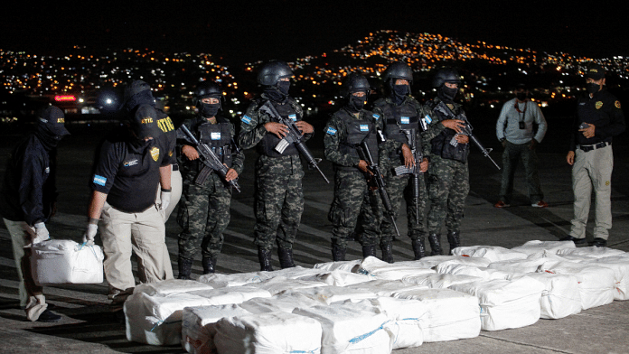 Officers of Honduras' Technical Agency for Criminal Investigation carry a package containing cocaine seized during a police operation in Tegucigalpa | Reuters file photo