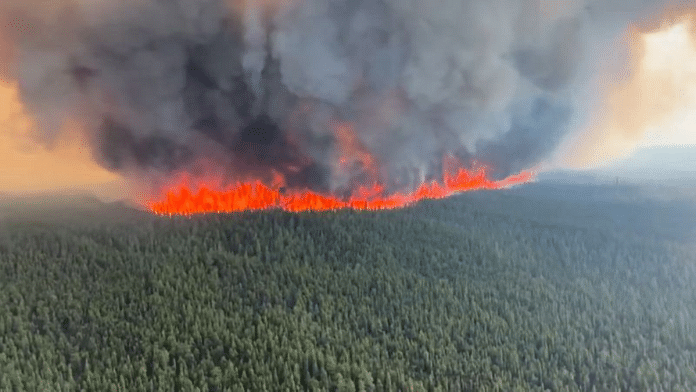 Smoke rises from a wildfire in Tumbler Ridge, British Columbia, Canada, in this screen grab taken from a video | BC Wildlife Service/Handout via Reuters