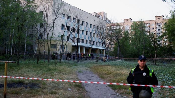 Emergency services personnel near a cordon after a Russian missile strike at a compound of a municipal clinic, amid Russia’s attack on Ukraine, in Kyiv on 1 June, 2023/Reuters