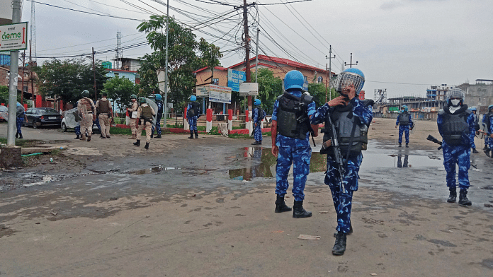 Security personnel stand guard during a protest over the killing of nine civilians, at Konung Mamang in Imphal on Thursday | ANI