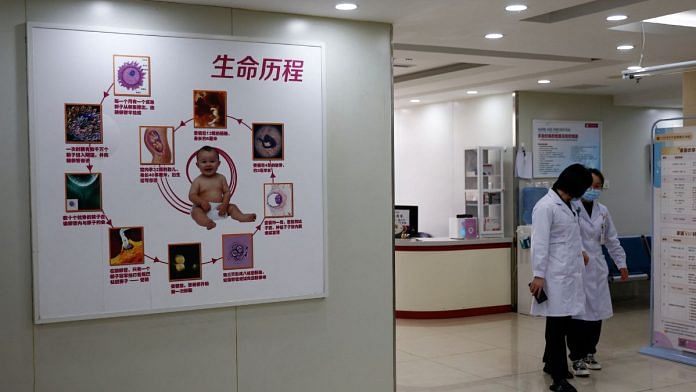 Staff members walk past the waiting area of the assisted reproductive centre at the Beijing Perfect Family Hospital, which specialises in fertility treatments, in Beijing, China | Reuters/Tingshu Wang/File Photo