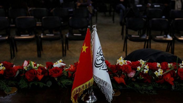 The flags of the China and the Islamic Emirate of Afghanistan are displayed during a news conference held by Afghan Deputy Prime Minister Mullah Abdul Ghani Baradar and Wang Yu, China's ambassador in Afghanistan, in Kabul, Afghanistan | Reuters/Ali Khara/File photo