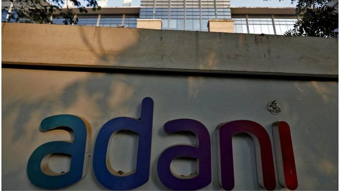 The logo of the Adani Group is seen on the wall of its realty office building on the outskirts of Ahmedabad/File Photo: Reuters