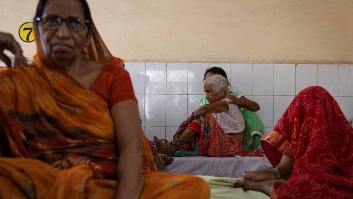 Shanti Devi, 80, who is suffering from breathing difficulties suspected to be heat-related, sits on a bed inside a hospital ward in Ballia District in the northern state of Uttar Pradesh, India | Reuters/Adnan Abidi