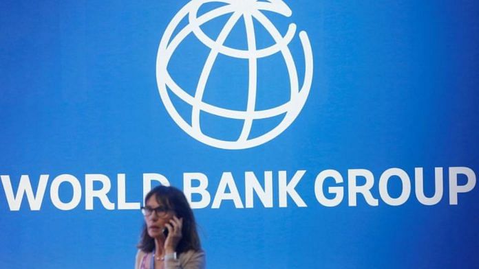 A participant stands near a logo of World Bank at the International Monetary Fund/File Photo: Reuters