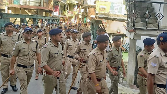 Uttarakhand Police conduct a flag march after the imposition of Section 144 CrPC amid communal tensions in Purola Wednesday | ANI