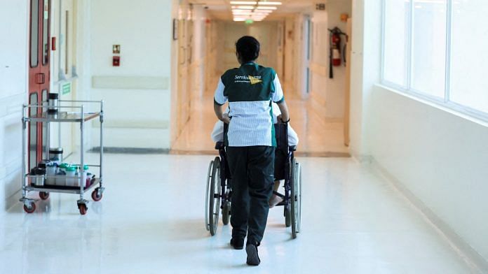 A hospital attendant wheels a patient through a hospital in New Delhi | Reuters file photo