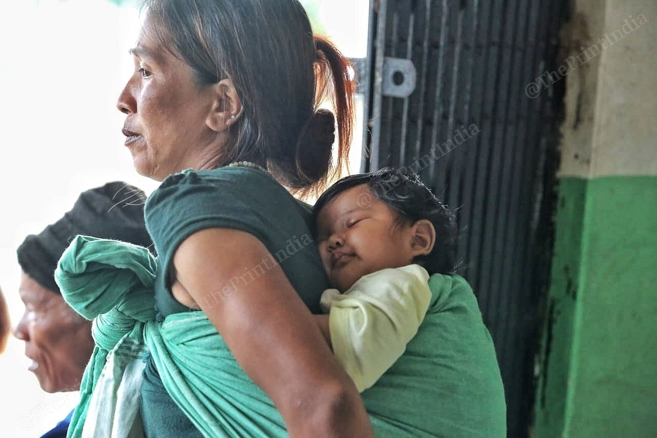 Women carry a child on her back Photo: Praveen Jain | ThePrint