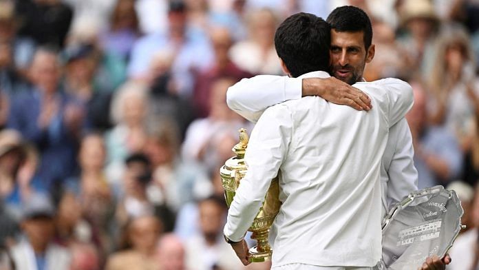 Serbia's Novak Djokovic with Spain's Carlos Alcaraz after losing the final in All England Lawn Tennis and Croquet Club, London | Reuters