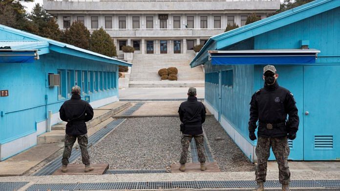 South Korean soldiers stand guard during a media tour at the Joint Security Area (JSA) on the Demilitarized Zone (DMZ) in the border village of Panmunjom in Paju, South Korea | Pool via Reuters