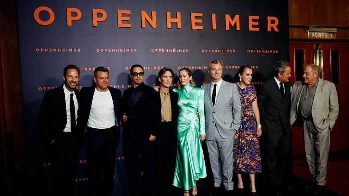 Cast members Trond Fausa Aurvag, Matt Damon, Robert Downey Jr., Cillian Murphy, Emily Blunt, Jason Clarke, Director Christopher Nolan and his wife Emma Thomas, and Producer Charles Roven pose during a photocall before the premiere of the film 