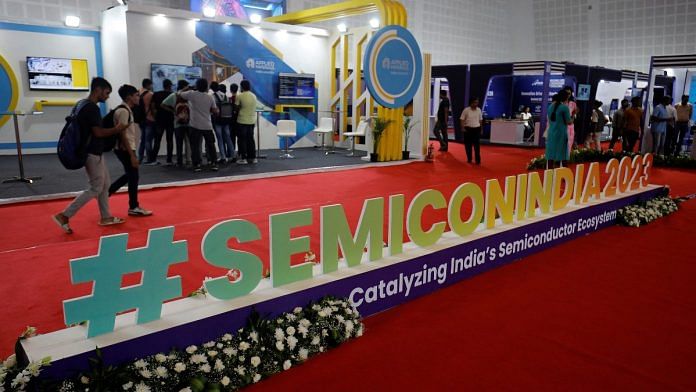Visitors gather at Applied Materials and Micron Technology kiosks before the start of 'SemiconIndia 2023', India's annual semiconductor conference, in Gandhinagar, India | Reuters