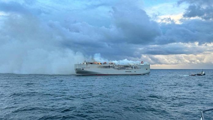 Smoke rises as a fire broke out on the cargo ship Fremantle Highway, at sea on July 26, 2023 | Handout via Reuters