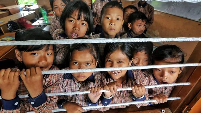 Children looking out of a window at Eastern Ideal High School, Akampat | Praveen Jain | ThePrint