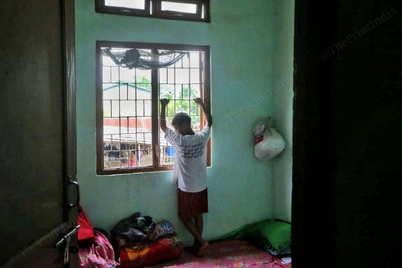 A boy looks out of the window in the camp | Photo: Praveen Jain | ThePrint