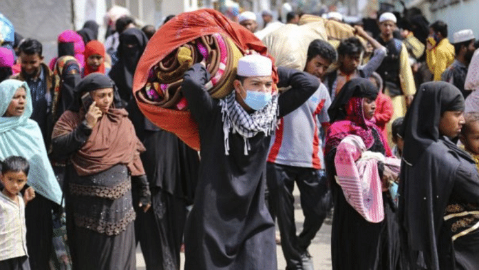 Rohingya Muslims leave their settlement for a centre following a police verification drive, in Jammu, Sunday, March 7, 2021. Credit: PTI Photo