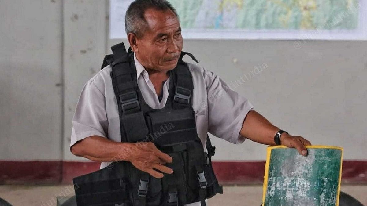Kanaan village defence committee commander George Thang shows how they fashion bulletproof jackets out of iron poles | Praveen Jain | ThePrint
