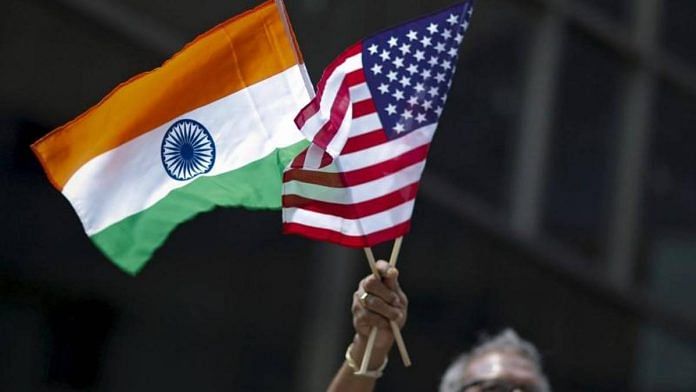 A man holds the flags of India and the US in New York | Photo: Reuters