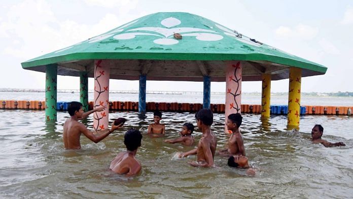 Children play with each other in a flooded area after the rise in the water level of the Ganga river, in Prayagraj, on 16 July 2023 | ANI photo