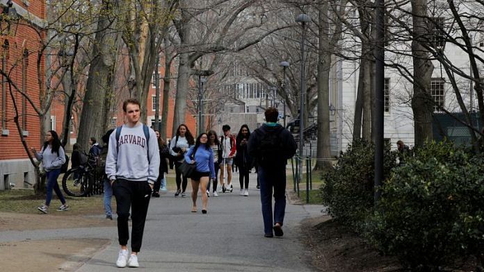 Students and pedestrians walk through the Yard at Harvard University/File Photo: Reuters