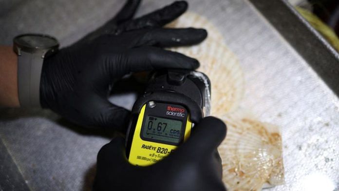 An official measures radiation levels of scallops imported from Japan as they conduct a radioactivity check, which have been conducted regularly since the 2011 Fukushima disaster, at Noryangjin fisheries wholesale market in Seoul, South Korea, July 6, 2023 | Reuters