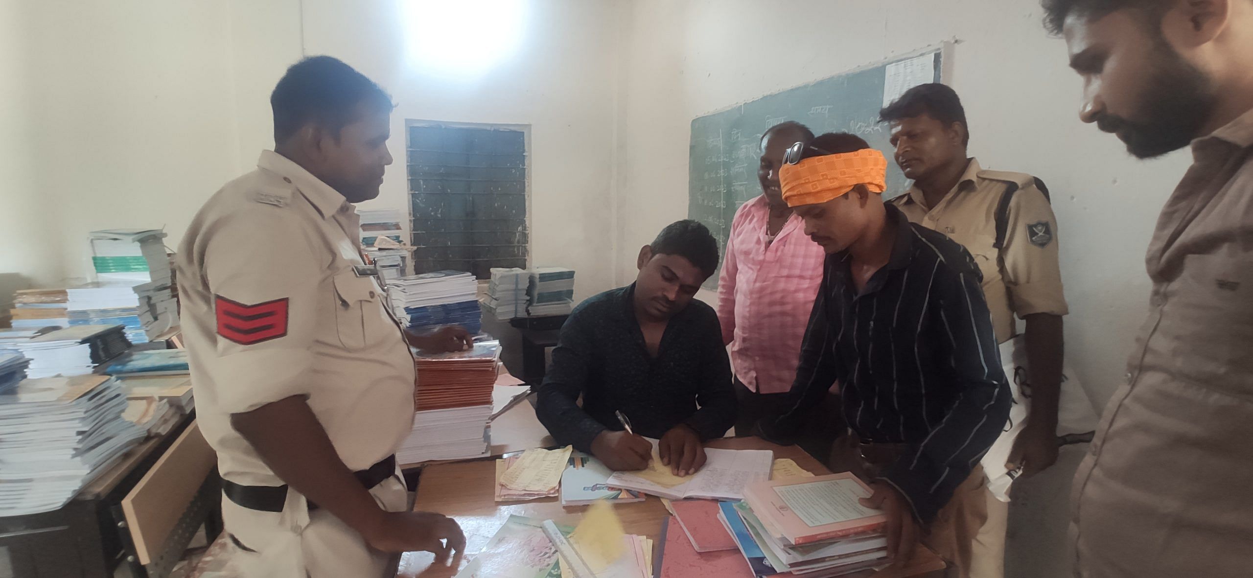 Dashmat along with two constables, collecting books for his son Rahul after completing the admission process and paying his school fees for class nine at Higher Secondary School, Sapahi | Iram Siddique, ThePrint