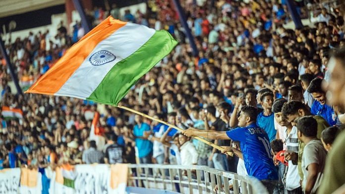A fan waves the national flag | Representational image | ANI file photo