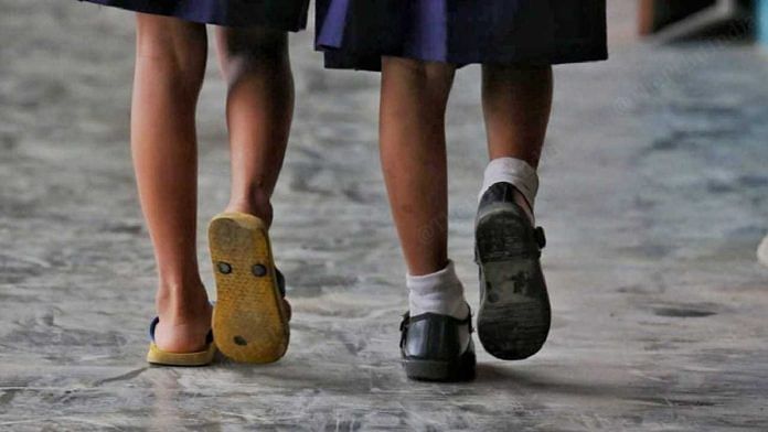 A displaced student wearing slippers with a peer wearing shoes at Eastern Idea High School | Praveen Jain | ThePrint
