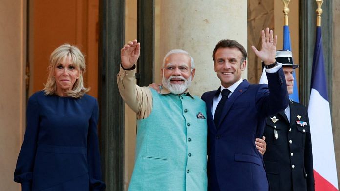 French President Emmanuel Macron and his wife Brigitte Macron welcome Indian Prime Minister Narendra Modi at the Elysee Palace, in Paris, France, July 13, 2023 | Reuters