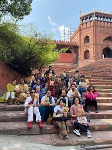 The group at the stairs of Jama Masjid, posing with a copy of Madhur Gupta's Courting Hindustan | By special arrangement