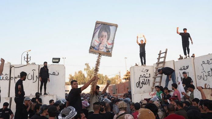 Protesters clash with security forces members as they gather near the Swedish embassy in Baghdad, on 20 July 2023 | Reuters