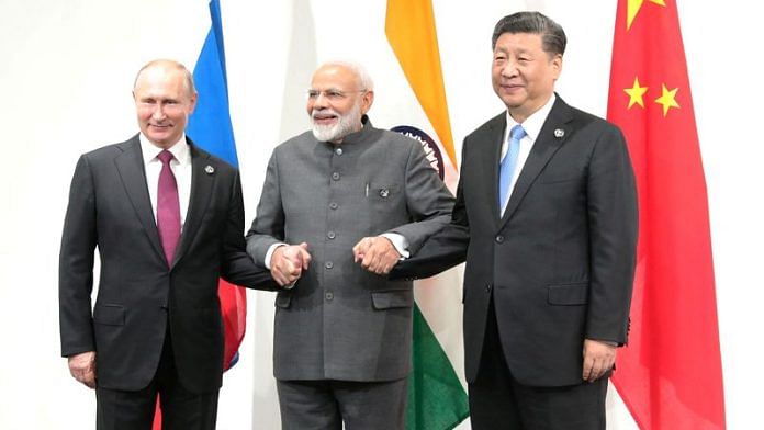 Russia's President Vladimir Putin (L), India's Prime Minister Narendra Modi (C) and China's President Xi Jinping pose for a picture during a meeting on the sidelines of the G20 summit in Osaka, Japan June 28, 2019 | Reuters
