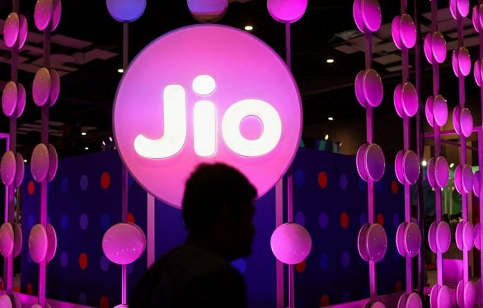 A man walks across the LED board showing the logo of Jio at the India Mobile Congress 2022 at Pragati Maidan, in New Delhi | Reuters file photo