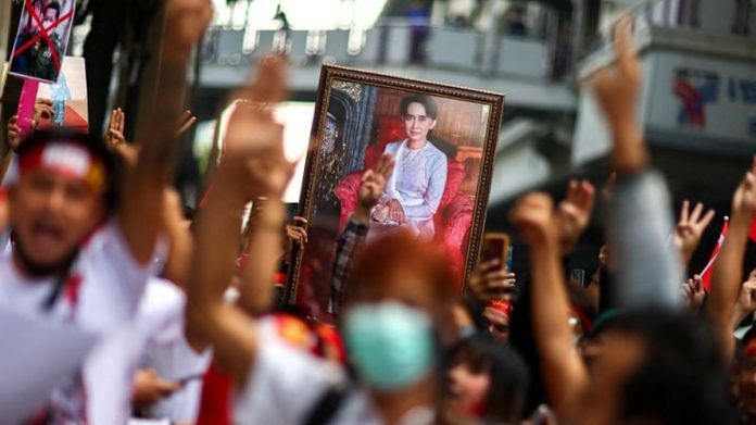 Protesters hold up a portrait of Aung San Suu Kyi and raise three-finger salutes, during a demonstration to mark the second anniversary of Myanmar's 2021 military coup, outside the Embassy of Myanmar in Bangkok, Thailand | REUTERS